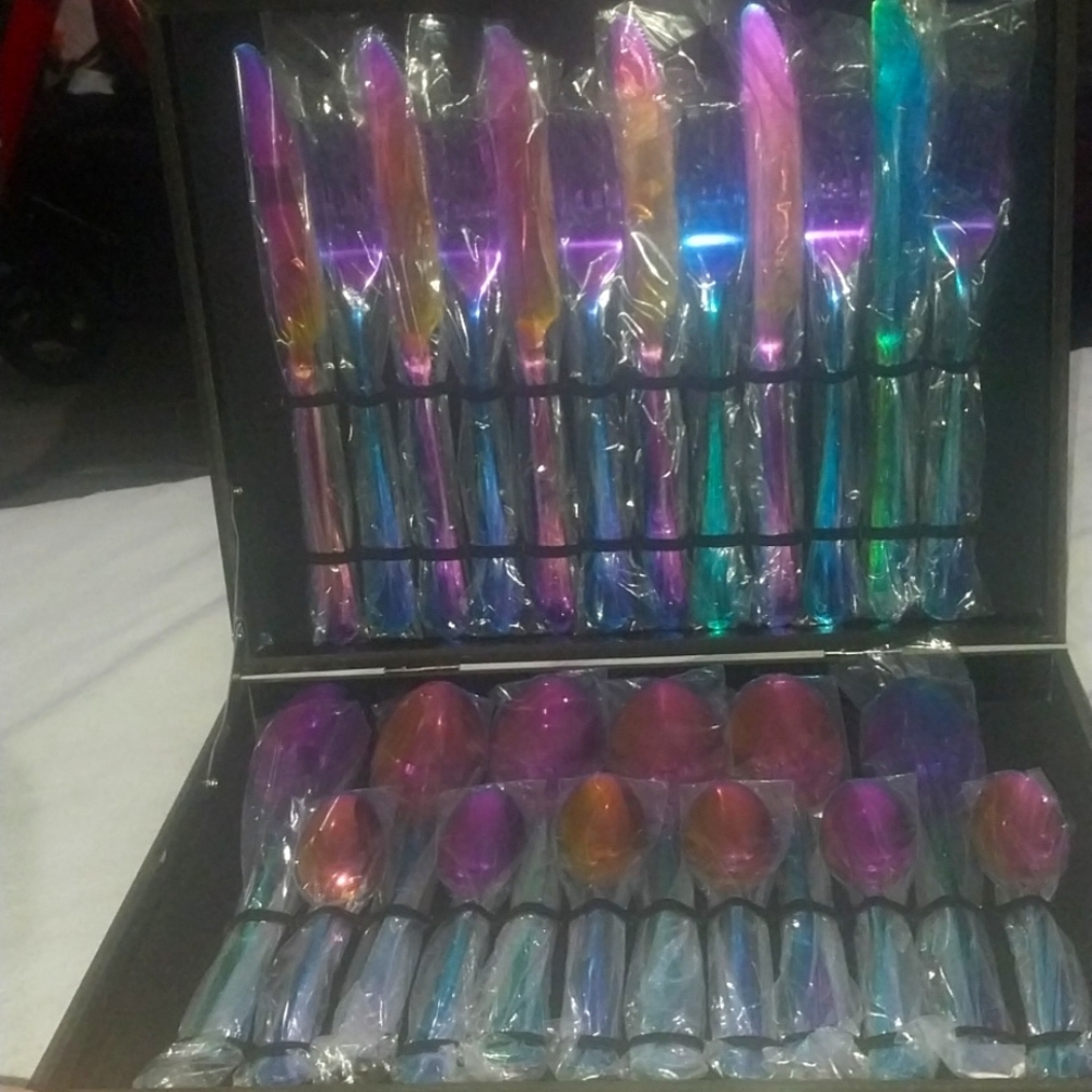 Twenty four piece individually wrapped rainbow colored iridescent flatware.